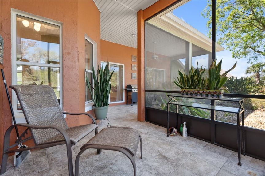 Large screened-in lanai with tranquil views of the marsh, perfect for relaxation and outdoor entertaining.