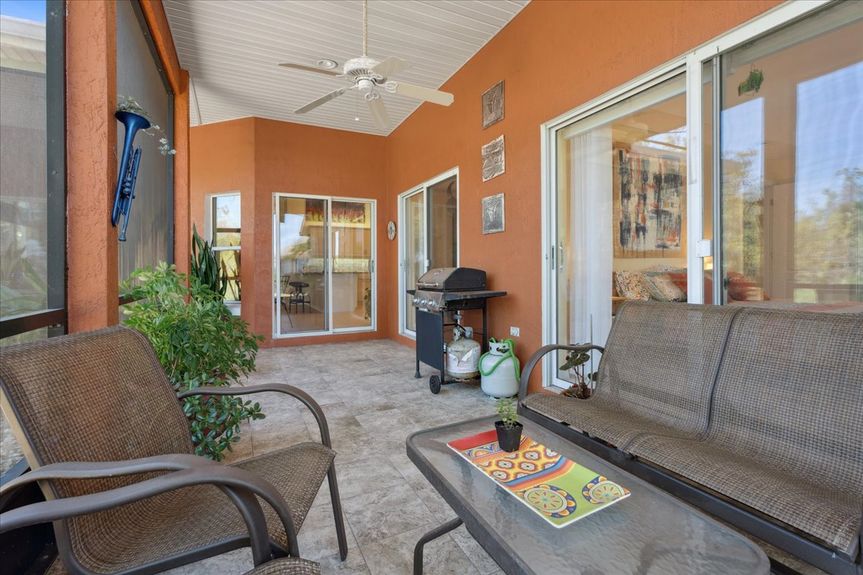 Large screened-in lanai with tranquil views of the marsh, perfect for relaxation and outdoor entertaining.