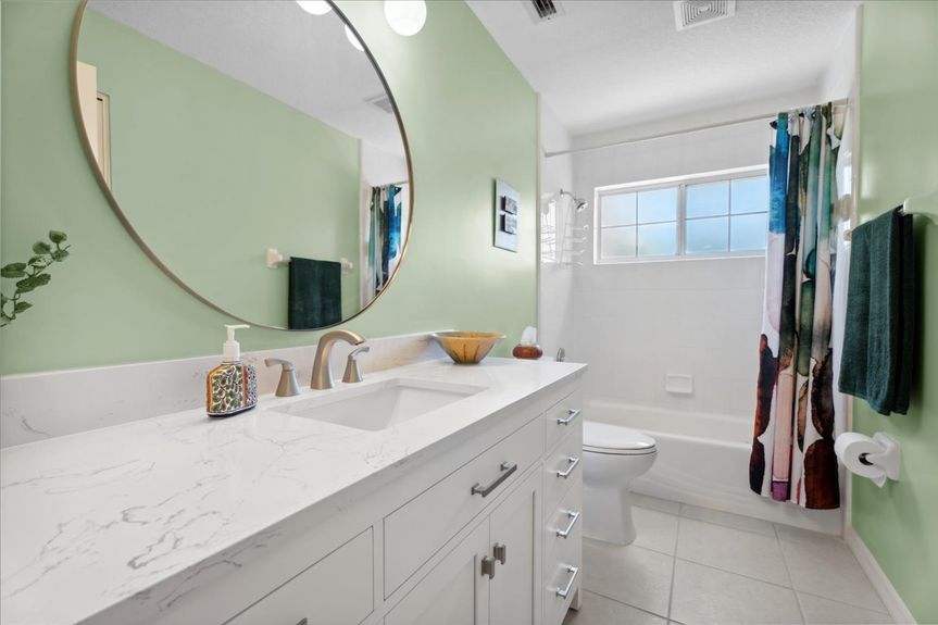 Freshly renovated guest bathroom with sleek fixtures, bright lighting, and a stylish vanity.