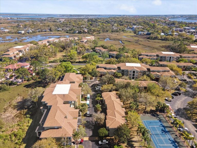 Aerial view of the Las Palmas community in St. Augustine, showcasing tree-lined streets, green spaces, and peaceful marsh views.