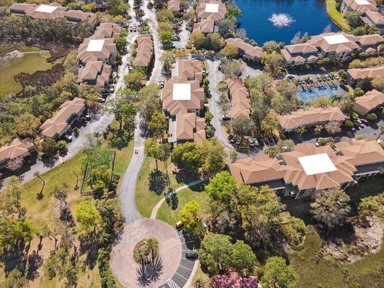 Aerial shot of the condo building at 4000 Grande Vista Blvd, Unit 15-104, showing its modern architecture and layout within the Las Palmas community.