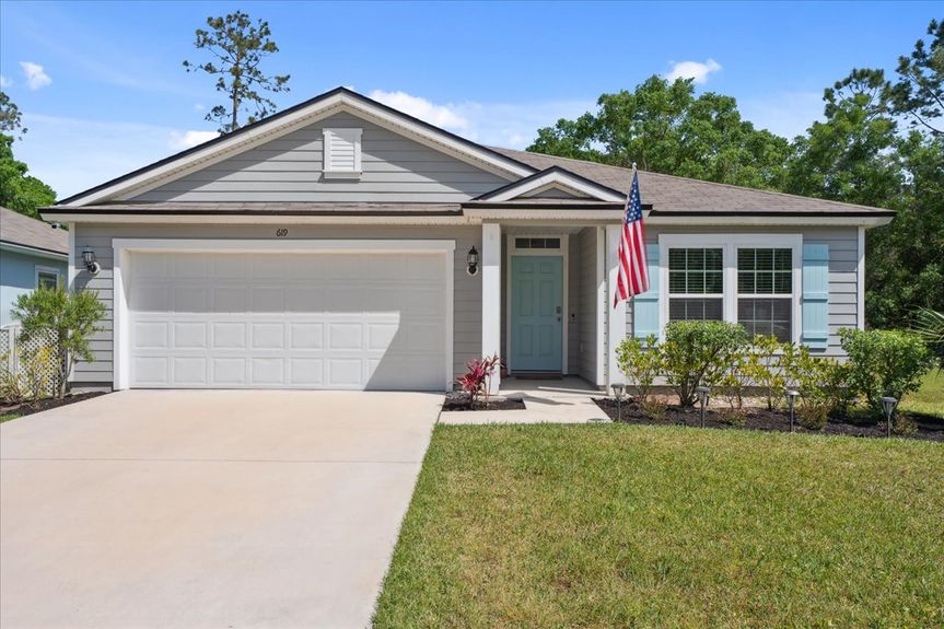 Front view of a single-story move-in ready home with 3 bedrooms, 2 baths, screened lanai, and pond views near community pool, pickleball courts, and fitness center.