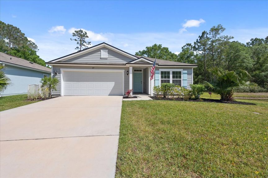 Front view of a single-story move-in ready home with 3 bedrooms, 2 baths, screened lanai, and pond views near community pool, pickleball courts, and fitness center.
