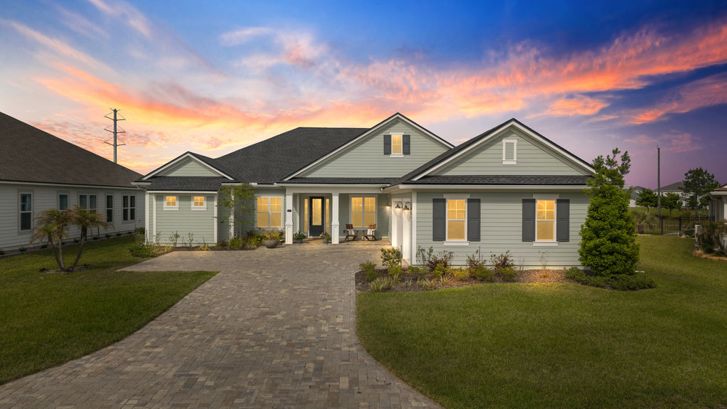 Front exterior of a modern single-family home at 22 Red Twig Way, featuring a manicured lawn and three-car garage