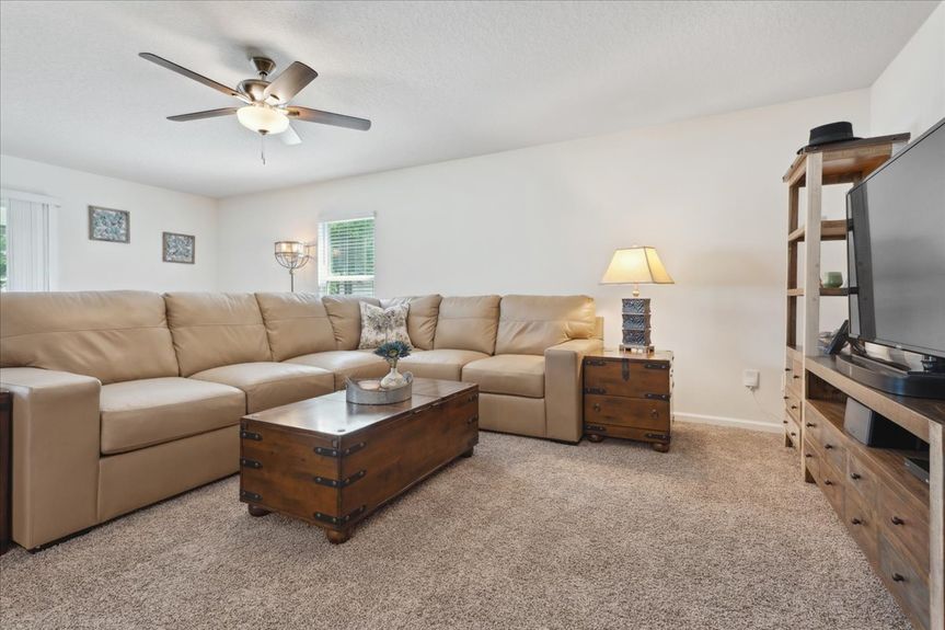 Single-story move-in ready home with 3 bedrooms, 2 baths, screened lanai, and pond views near community pool, pickleball courts, and fitness center.