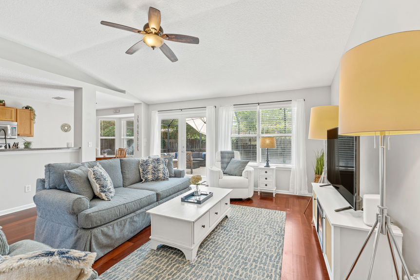Bright living room with natural light, open floor plan, and hardwood floors in St. Augustine home