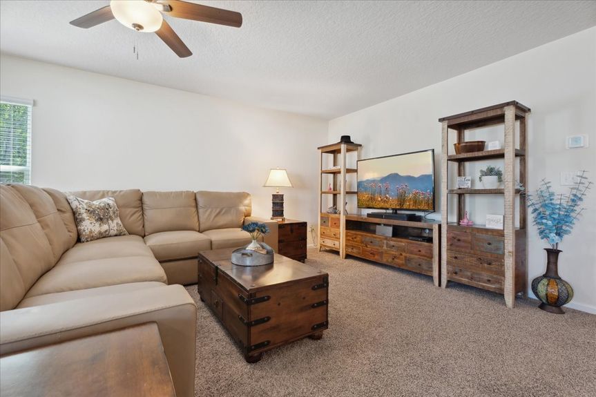 Single-story move-in ready home with 3 bedrooms, 2 baths, screened lanai, and pond views near community pool, pickleball courts, and fitness center.