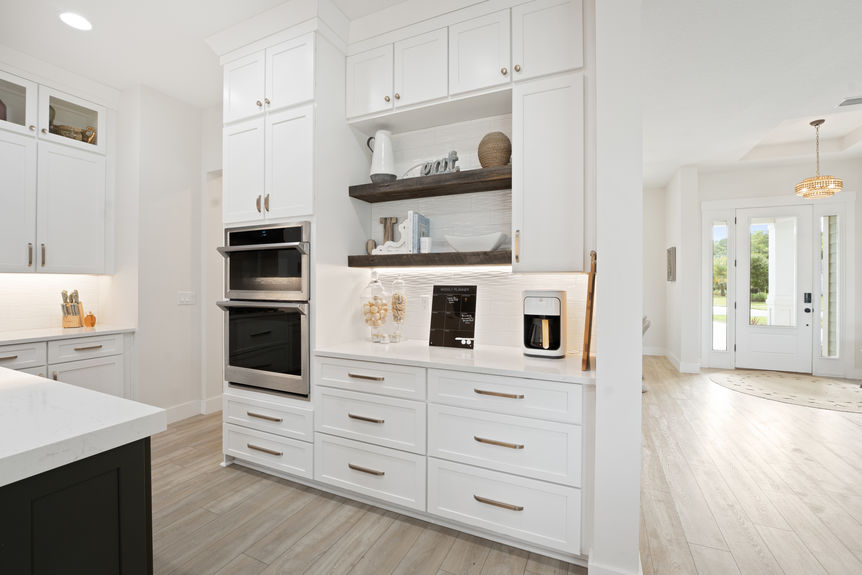 Spacious kitchen featuring quartz countertops, stainless steel appliances, and a large island with seating