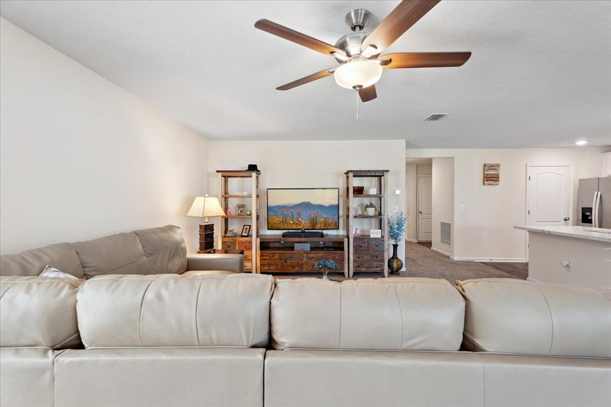 Single-story move-in ready home with 3 bedrooms, 2 baths, screened lanai, and pond views near community pool, pickleball courts, and fitness center.