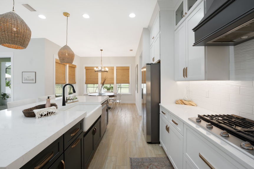 Spacious kitchen featuring quartz countertops, stainless steel appliances, and a large island with seating
