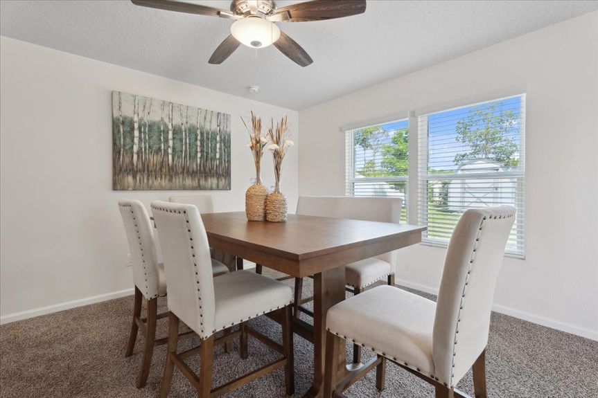 Single-story move-in ready home with 3 bedrooms, 2 baths, screened lanai, and pond views near community pool, pickleball courts, and fitness center.