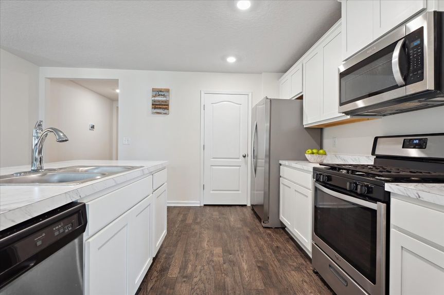 Single-story move-in ready home with 3 bedrooms, 2 baths, screened lanai, and pond views near community pool, pickleball courts, and fitness center.