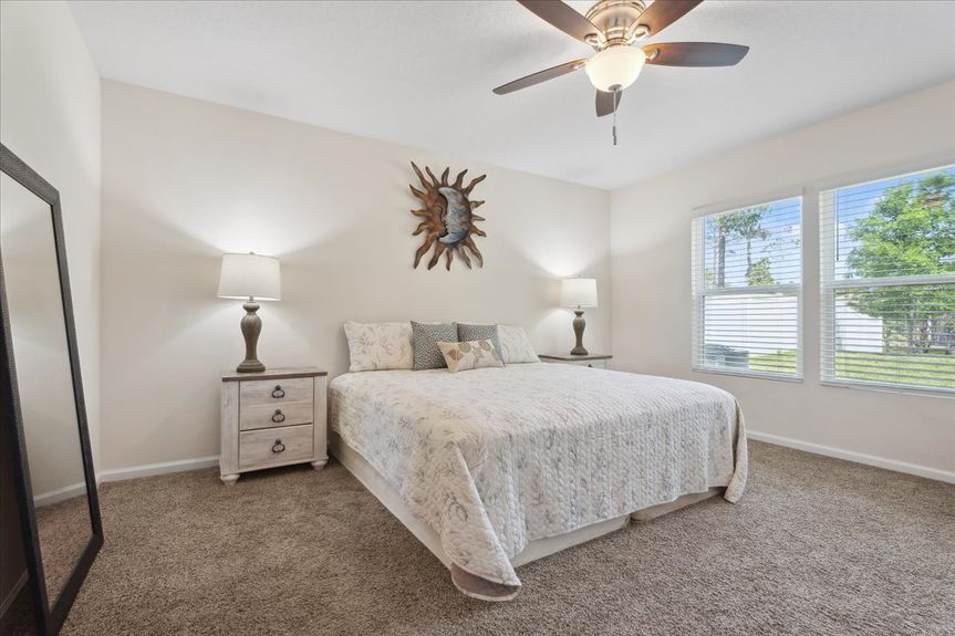 Single-story move-in ready home with 3 bedrooms, 2 baths, screened lanai, and pond views near community pool, pickleball courts, and fitness center.