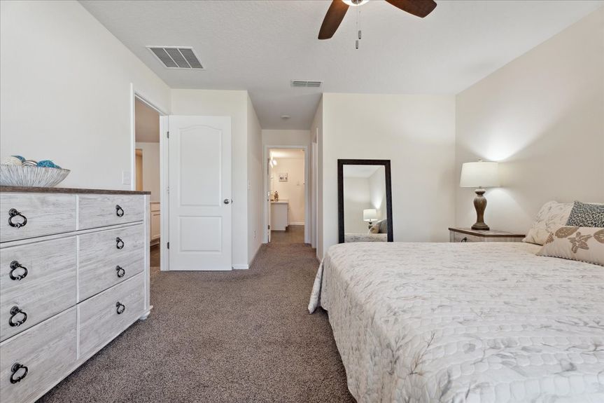 Single-story move-in ready home with 3 bedrooms, 2 baths, screened lanai, and pond views near community pool, pickleball courts, and fitness center.