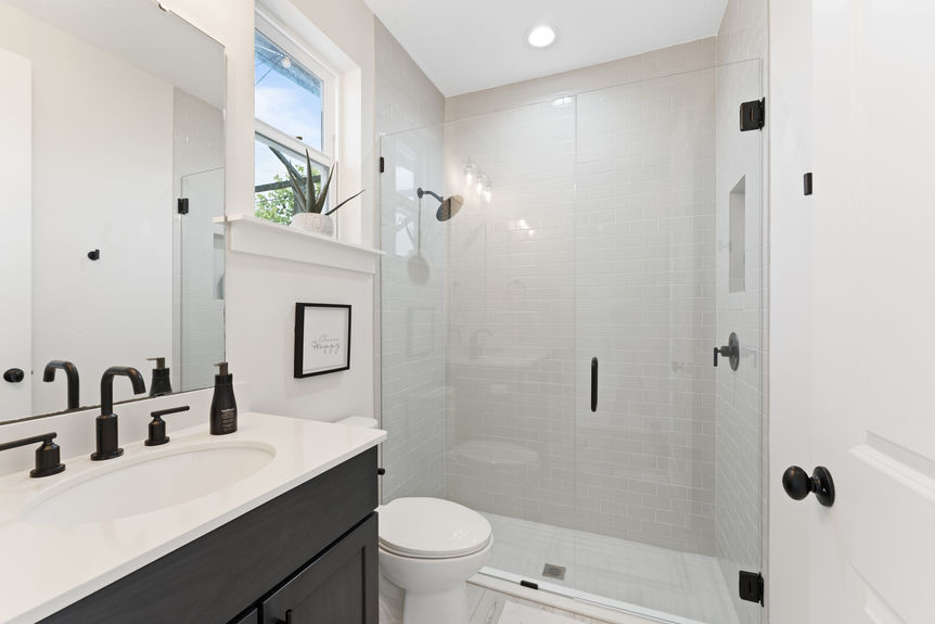 Primary bedroom featuring a spacious layout, large windows, and en-suite bathroom