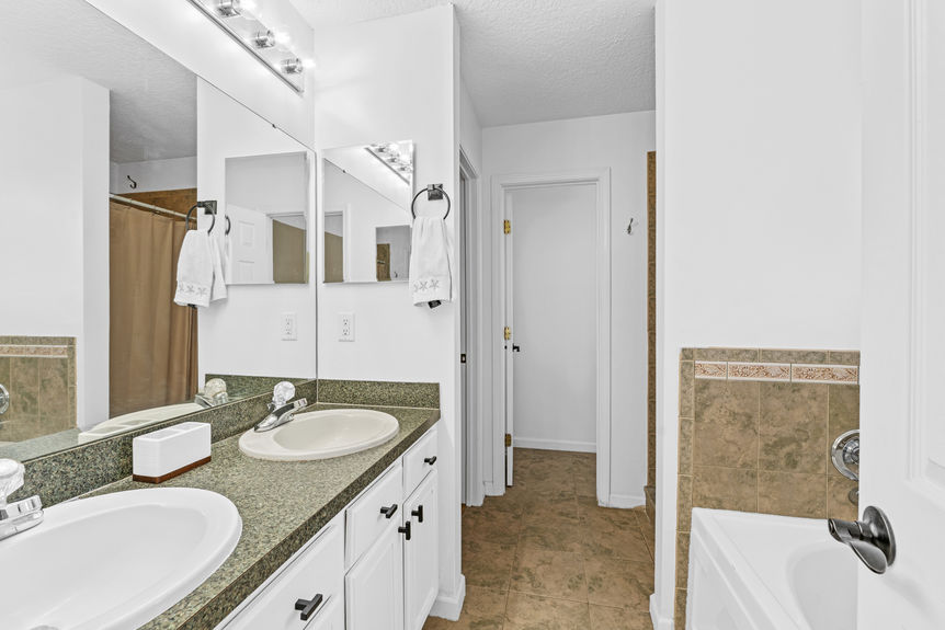 Bathroom with sleek vanity, neutral finishes, and natural light in St. Augustine pool home