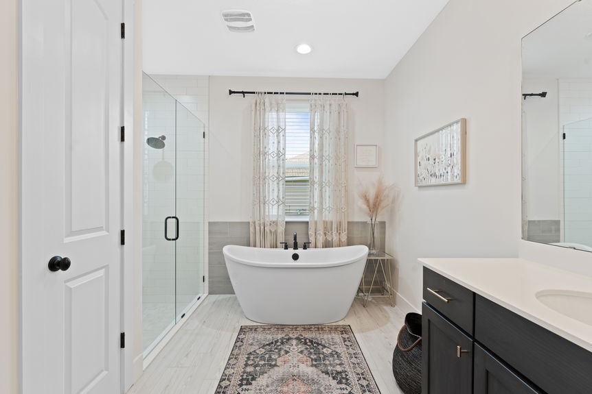 Primary bedroom featuring a spacious layout, large windows, and en-suite bathroom