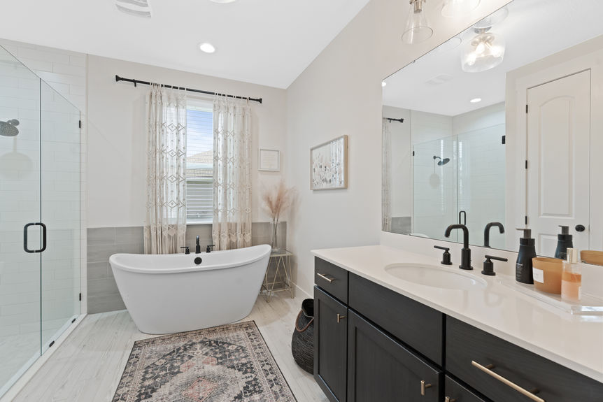 Primary bedroom featuring a spacious layout, large windows, and en-suite bathroom