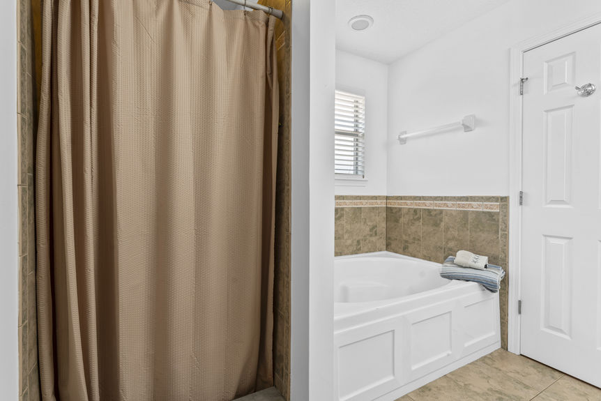 Bathroom with sleek vanity, neutral finishes, and natural light in St. Augustine pool home