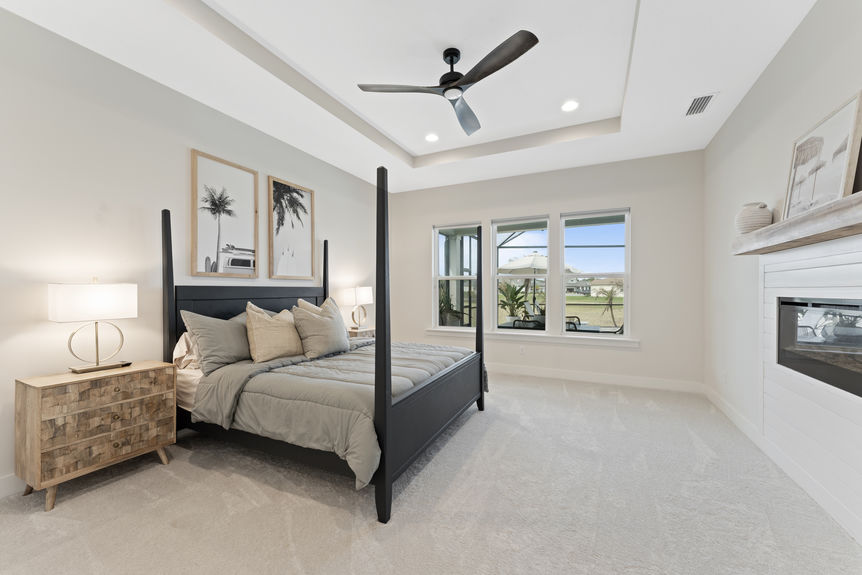 Primary bedroom featuring a spacious layout, large windows, and en-suite bathroom