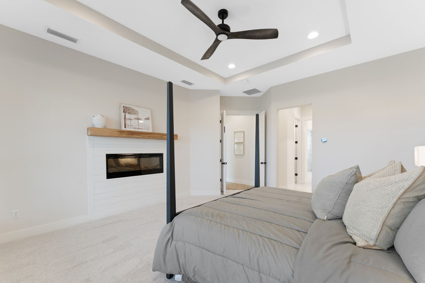 Primary bedroom featuring a spacious layout, large windows, and en-suite bathroom