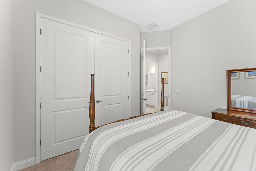 Bright and airy guest bedroom with large window and neutral tones in Madeira home