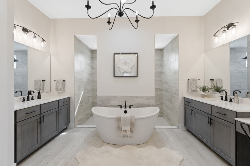 Primary bedroom featuring a spacious layout, large windows, and en-suite bathroom