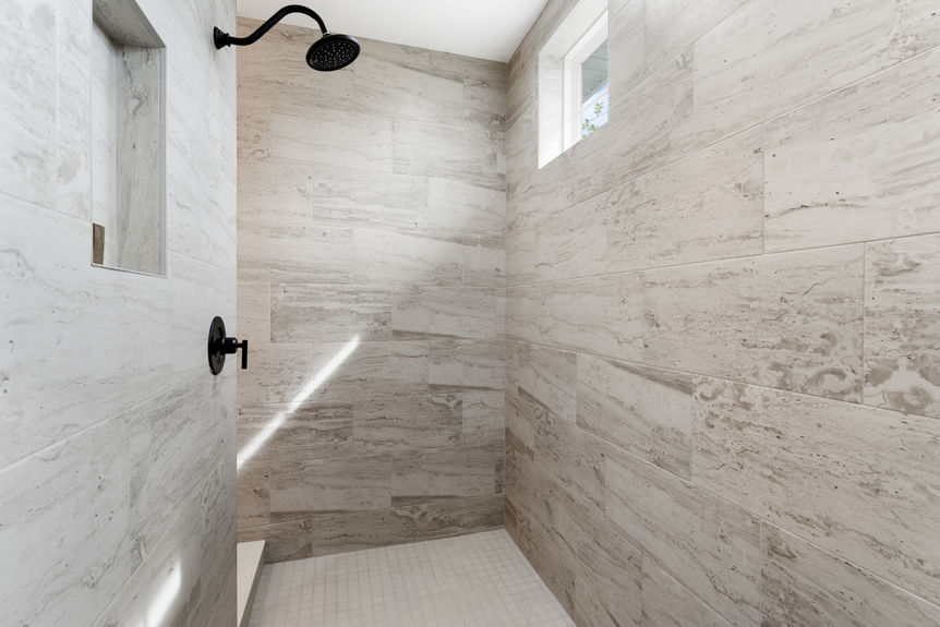 Primary bedroom featuring a spacious layout, large windows, and en-suite bathroom