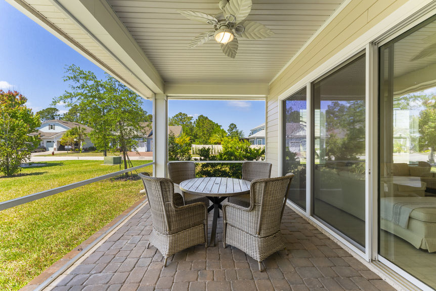 Covered and screened back lanai in Madeira home overlooking backyard