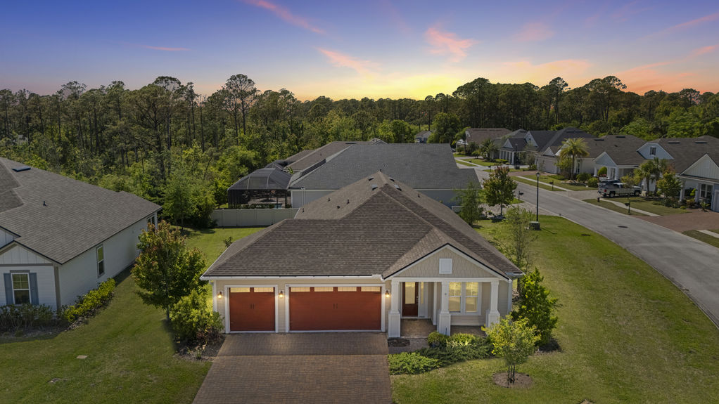 Evening Overhead view of a 3-bedroom home with 3-car garage on a corner lot in the Madeira community, St. Augustine