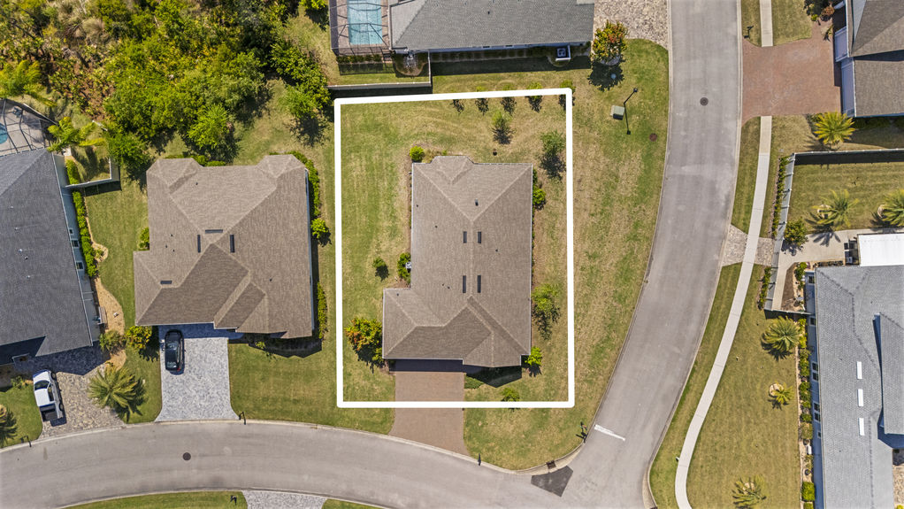 Overhead view of a 3-bedroom home with 3-car garage on a corner lot in the Madeira community, St. Augustine