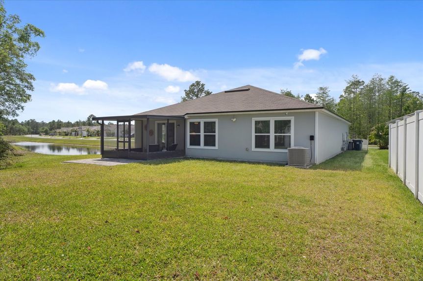 Single-story move-in ready home with 3 bedrooms, 2 baths, screened lanai, and pond views near community pool, pickleball courts, and fitness center.
