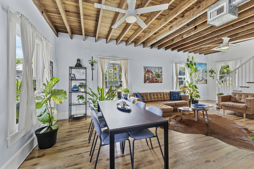 Living room with exposed wood beams, antique furnishings, and warm lighting in St. Augustine home