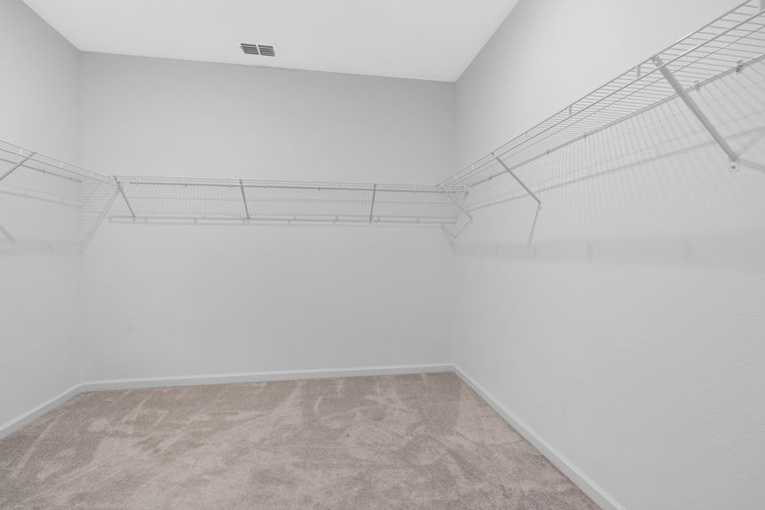 Laundry room in St Augustine home with built-in shelves and space for washer and dryer