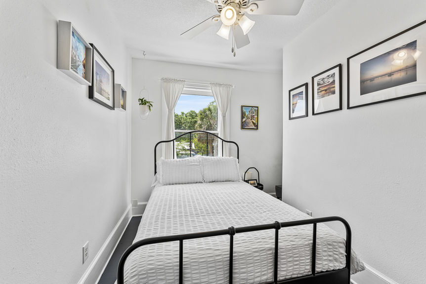 Upper-level bedroom with large window and cozy decor in Lincolnville St. Augustine property