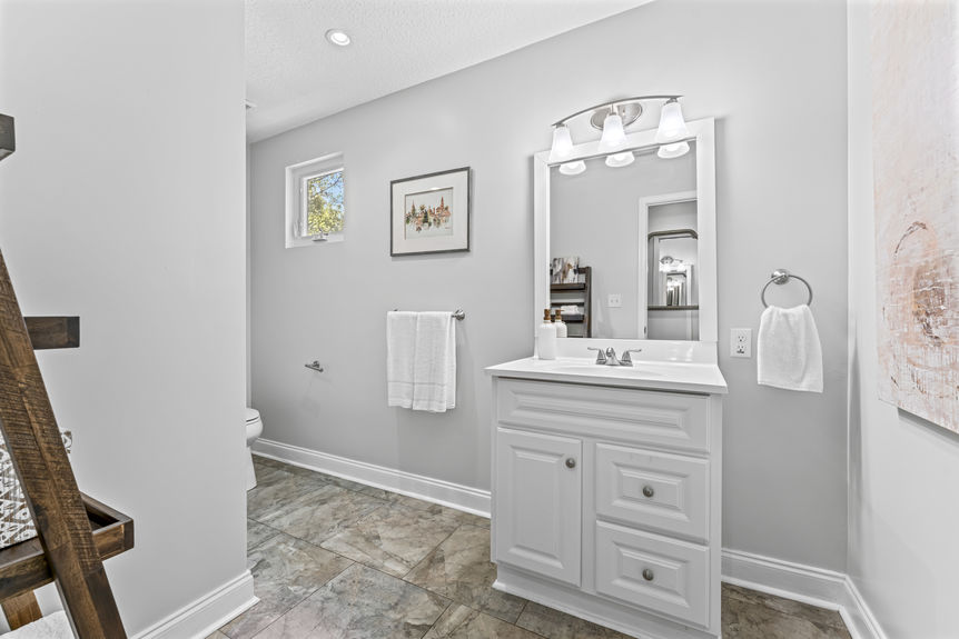 Modern bathroom with single vanity, sleek fixtures, and tile flooring in a St. Augustine home