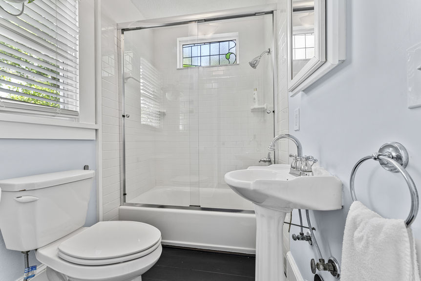 Bathroom with classic tile, updated fixtures, and vintage accents in Lincolnville St. Augustine home