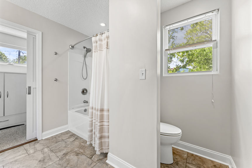 Bright bathroom with double sinks, white cabinetry, and modern lighting in a St. Augustine home