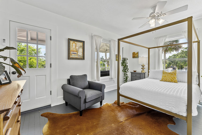 Upper-level bedroom with large window and cozy decor in Lincolnville St. Augustine property