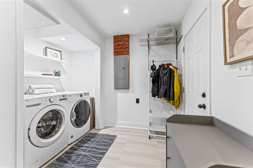 Compact laundry area with washer and dryer tucked into a closet space in a modern St. Augustine home