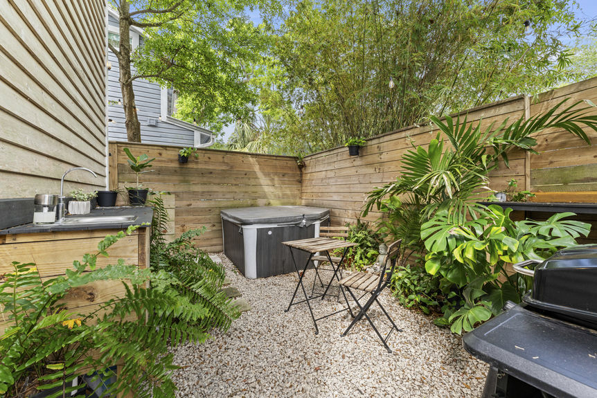 Backyard with hot tub, outdoor shower, and greenery at historic St. Augustine home