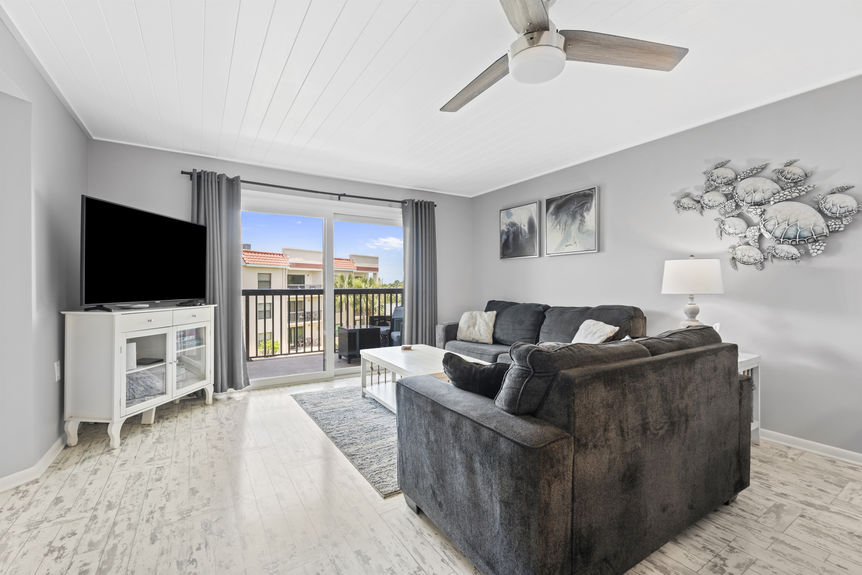 Open living and dining area with access to private balcony in St. Augustine Beach