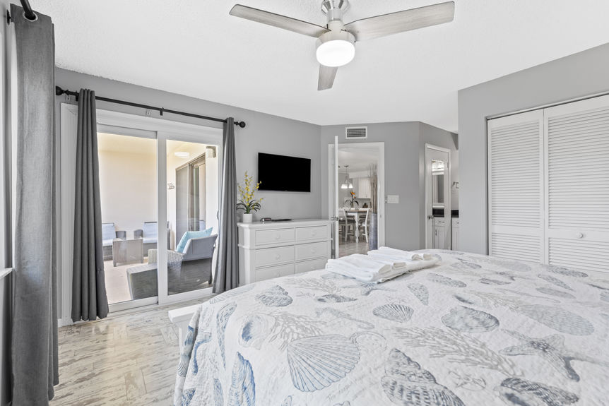 Bright bedroom with coastal décor and palm tree view