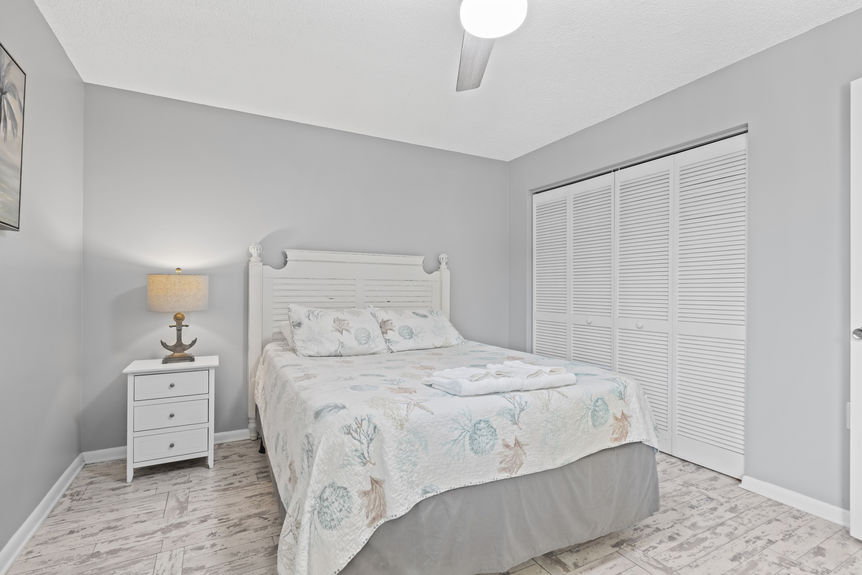 Bright bedroom with coastal décor and palm tree view