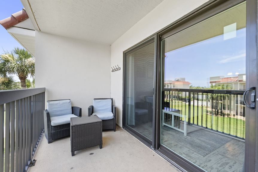 Ocean Village Club condo balcony with patio seating and palm tree views in St Augustine Florida