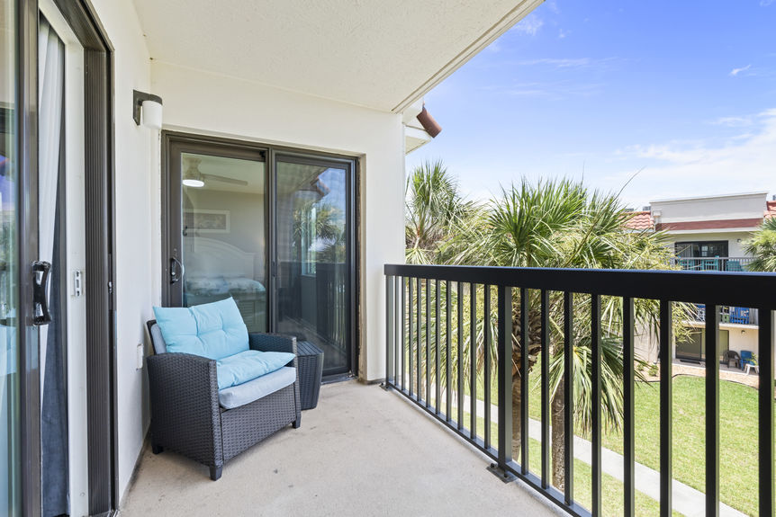 Ocean Village Club condo balcony with patio seating and palm tree views in St Augustine Florida