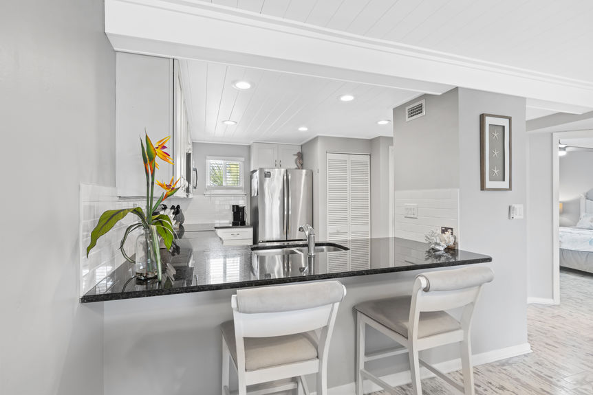 Bar seating area in a modern kitchen with granite countertop