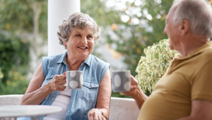 Senior couple enjoying coffee on a lanai near the beach in Florida