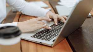 A seller comparing a Zestimate on a laptop with printed St. Augustine market comps.