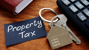 Property tax documents and calculator on a desk in a St. Augustine, Florida home